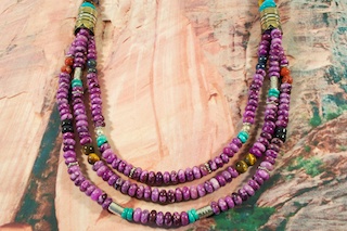 Beautiful 3 strand Necklace featuring Genuine Sugilite with accents of Turquoise, Blue Lapis, Tiger's Eye, Black Onyx and Picture Jasper. Sterling Silver and Gold Fill Barrels. Sterling Silver Beads, Cones and Clasp. Created by Navajo Artist Tommy Singer. Signed by the artist.